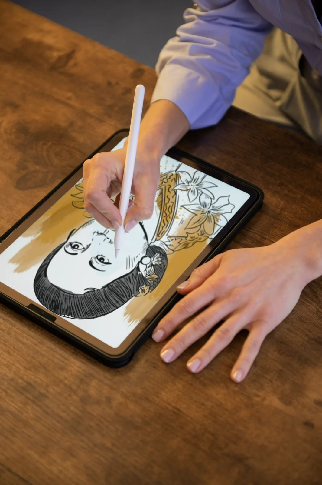 Illustrator drawing a character on a tablet with a stylus